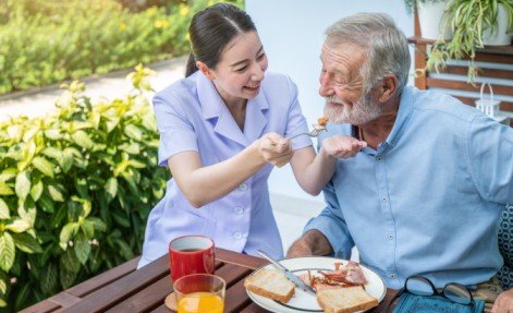 PSW assisting an elderly woman with daily living activities in Toronto